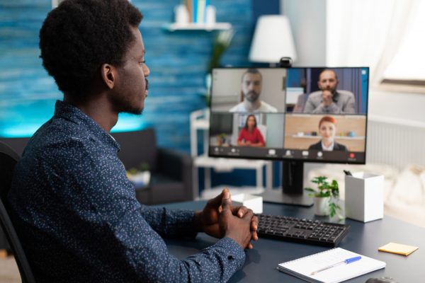 man-of-african-ethnicity-using-conference-webcam-communication man-of-african-ethnicity-using-conference-webcam-communication